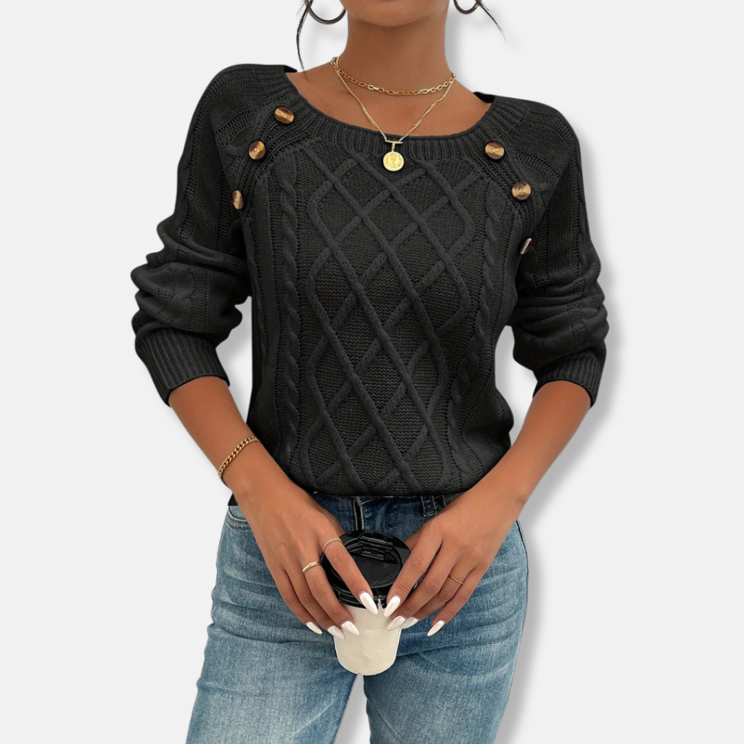 Women's relaxed-fit cable knit top with dropped shoulders, button accents, and ribbed cuffs