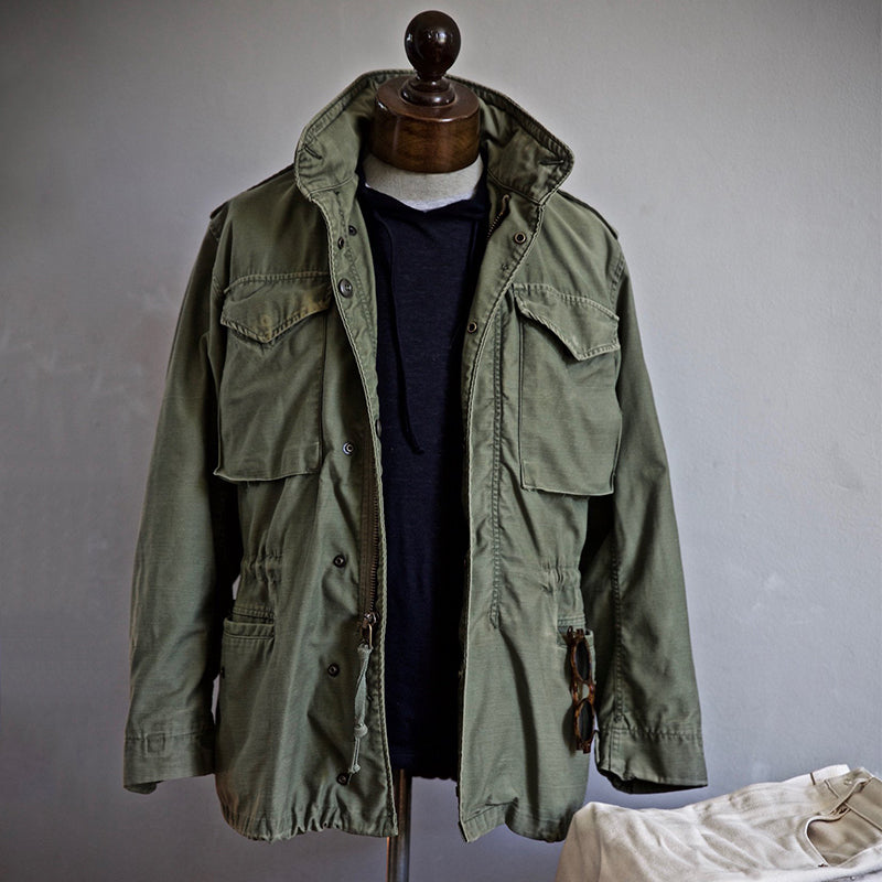 Olive green M65 field jacket Vietnam era military cut with bi-articulated back windproof heritage design