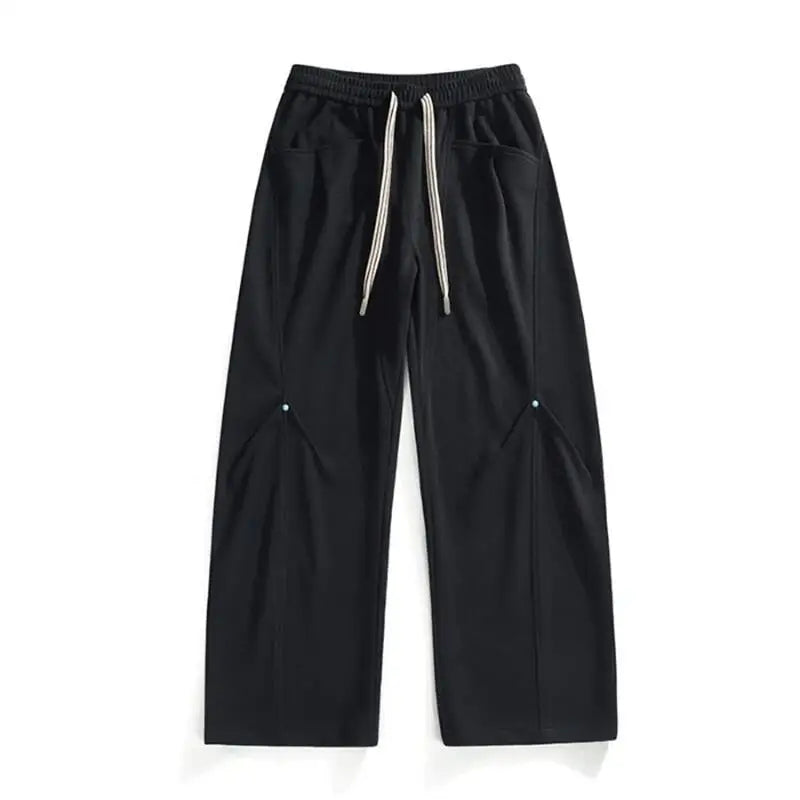 Black panel cut wide-leg sweatpants exaggerated silhouette striped drawstrings elastic waistband streetwear