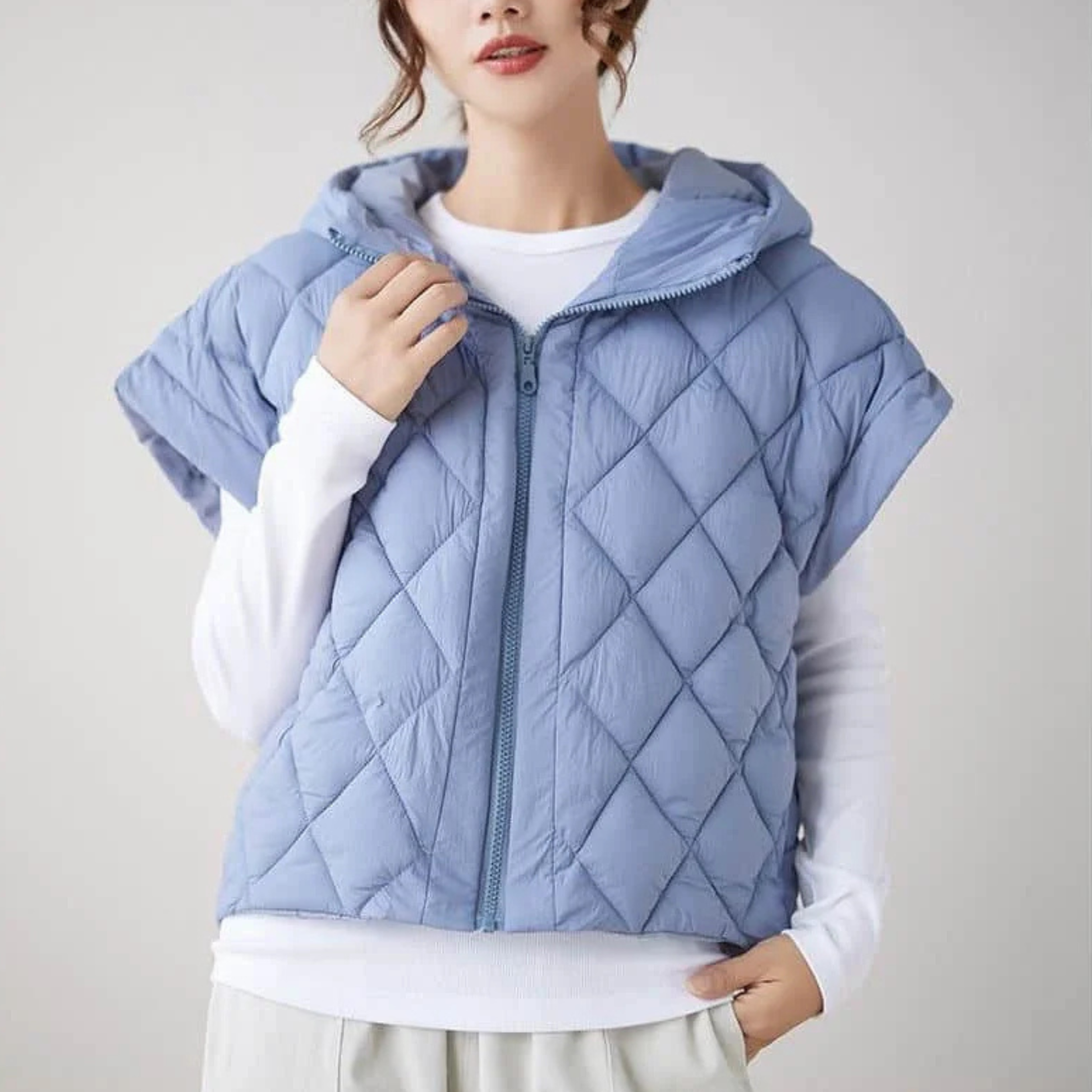 Women's quilted cap sleeve vest with hood, diamond quilt exterior, cropped silhouette, soft lining