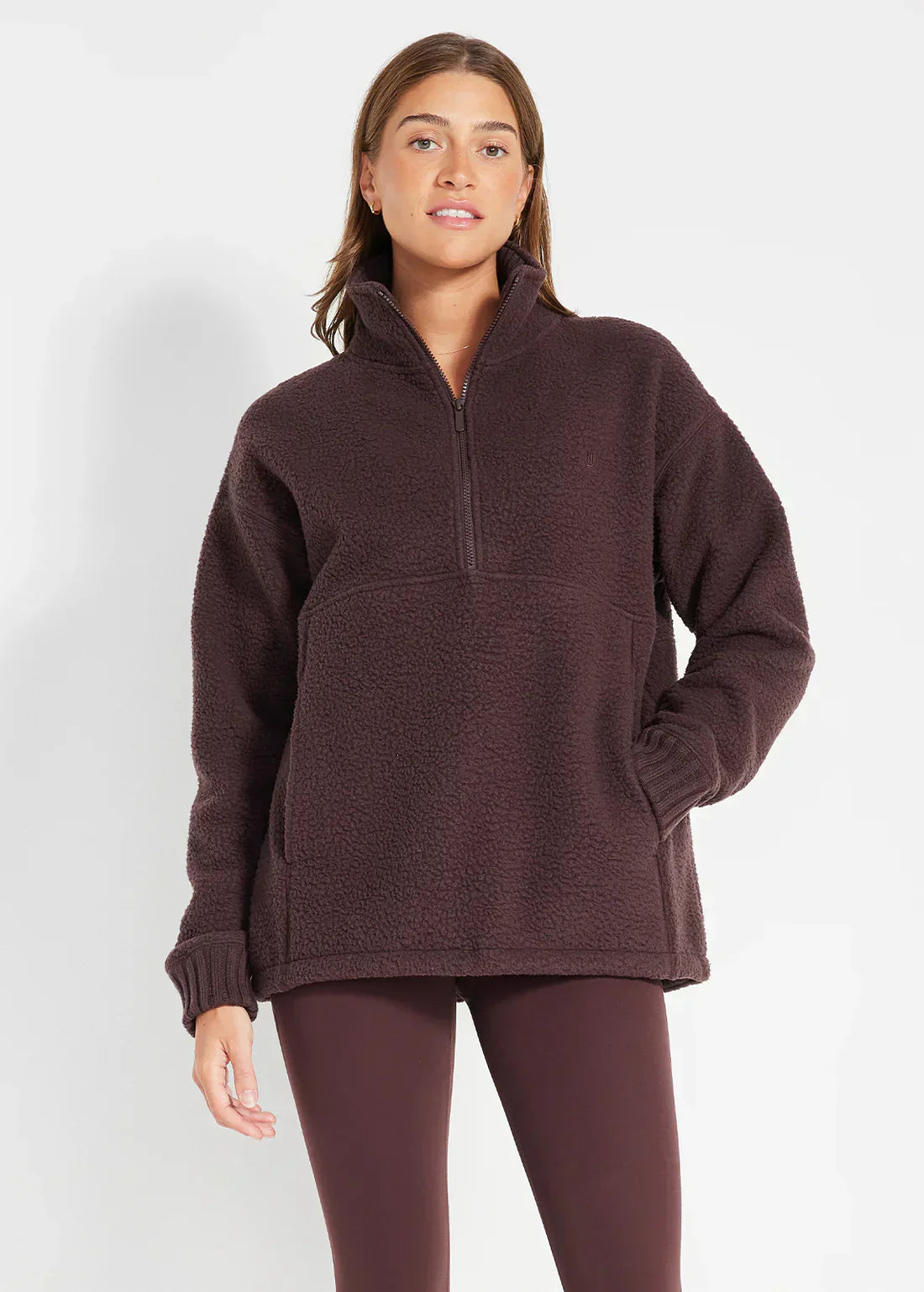 Navy blue half-zip fleece sweater with cozy textured fabric and adjustable neckline for outdoor wear