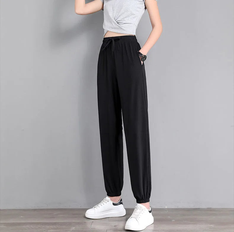 Light gray tapered jogger pants with adjustable drawstring waist and elastic cuffs for active wear