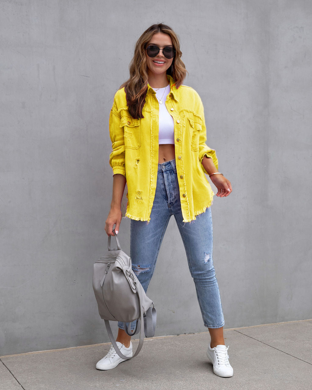 Women's relaxed shirt jacket with distressed detailing in chic urban style for transitional wear