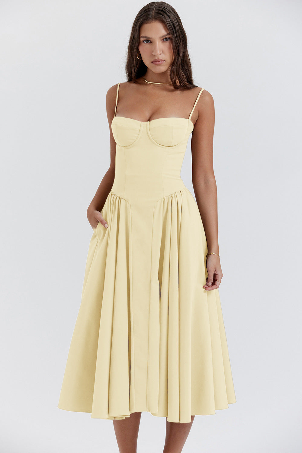Elegant pleated midi dress with slim straps, flared skirt, and hidden pockets for spring