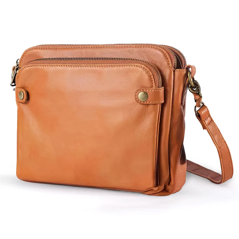 Women's faux leather crossbody bag with zipper closure, adjustable strap, and multiple compartments