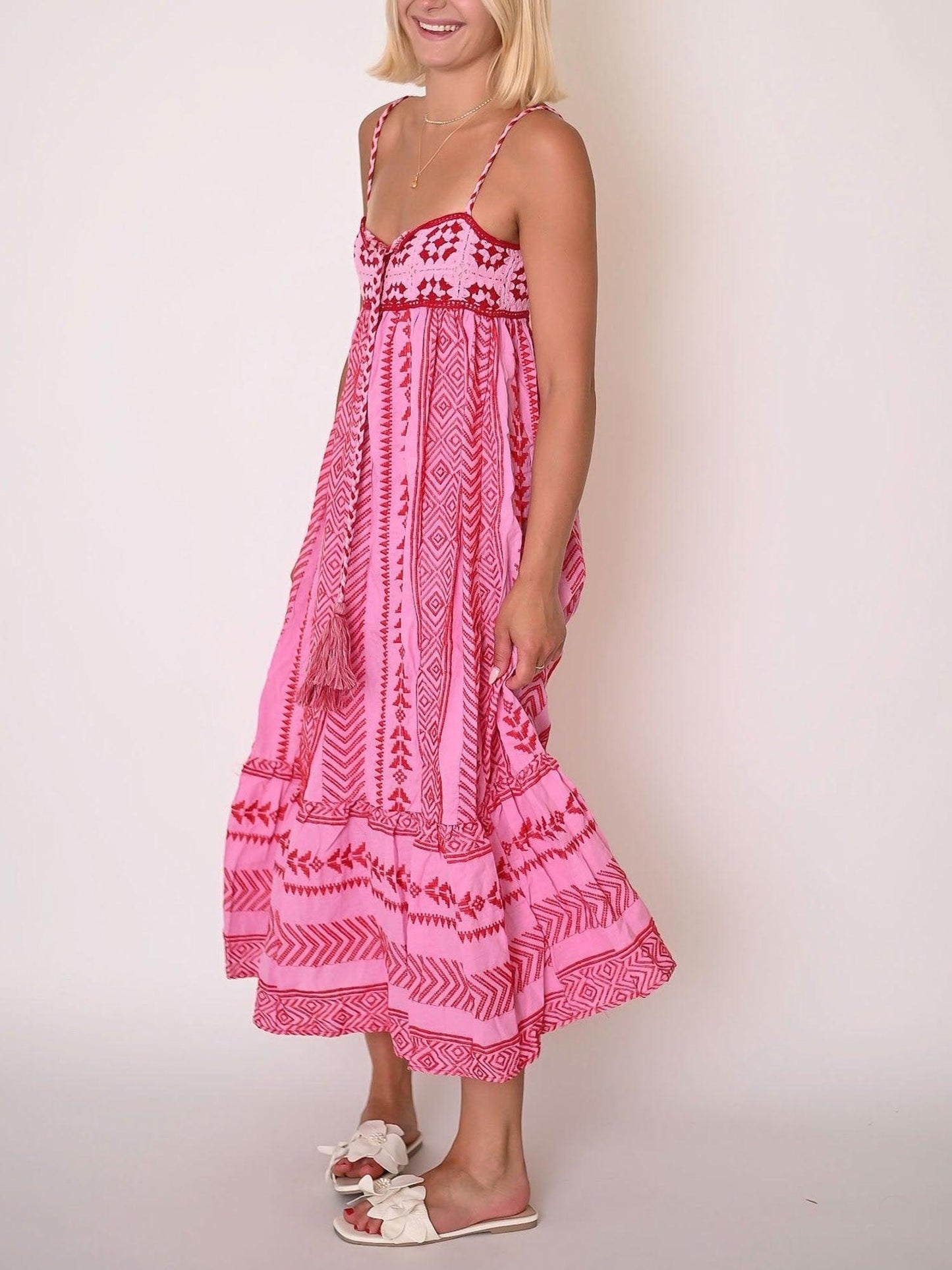 Pink embroidered midi dress with breezy comfort fit, playful elegant print, and feminine silhouette