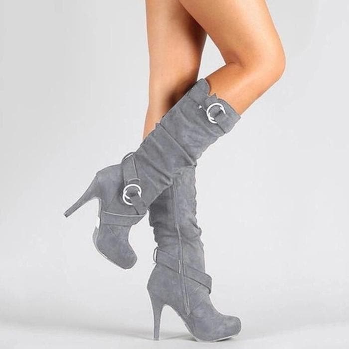 Women's black slouchy knee-high stiletto boots with decorative buckles and pointed toe
