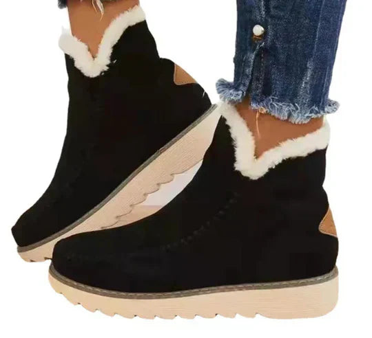 Women's plush sheepskin boots in warm tones, cozy ankle silhouette with soft fur lining