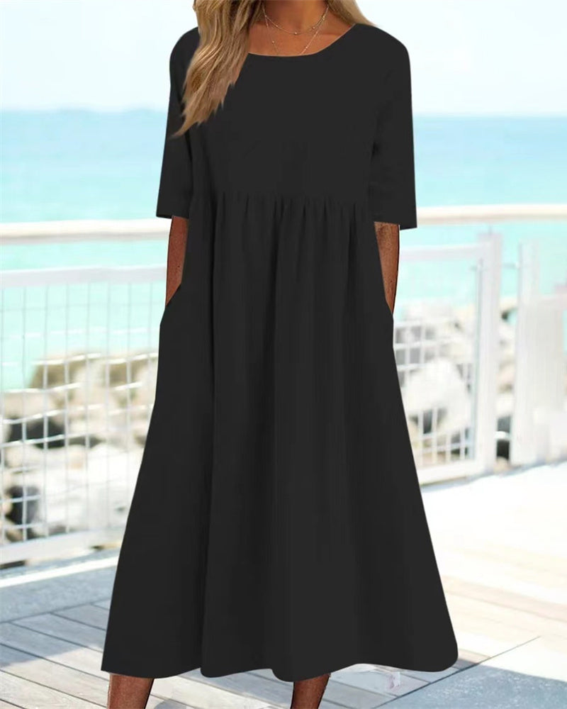 Women's relaxed A-line midi dress with round neckline and functional pockets for everyday wear