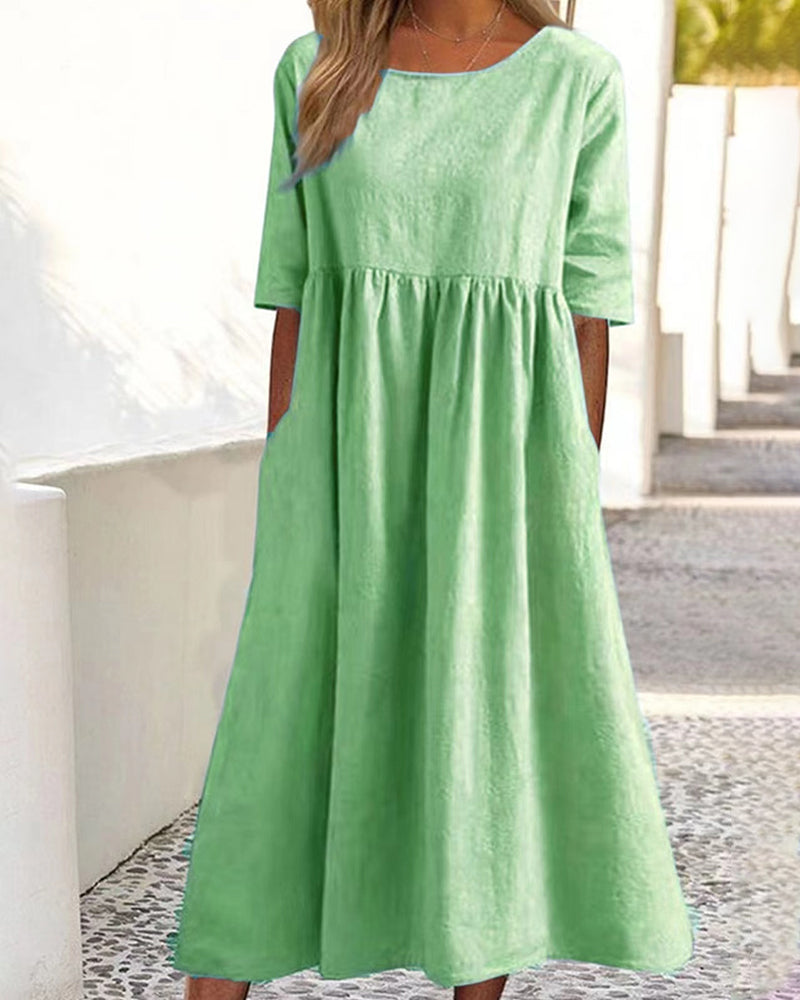 Women's relaxed A-line midi dress with round neckline and practical pockets for everyday wear