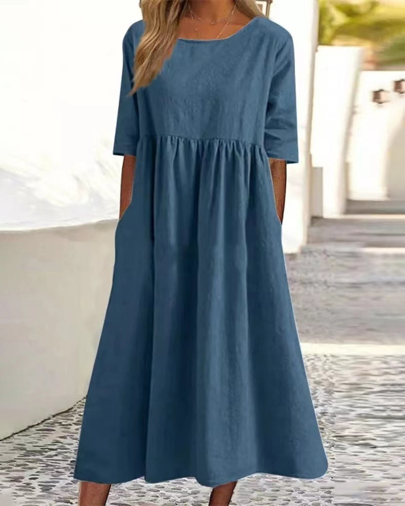 Women's relaxed A-line midi dress with round neckline and functional pockets for everyday wear