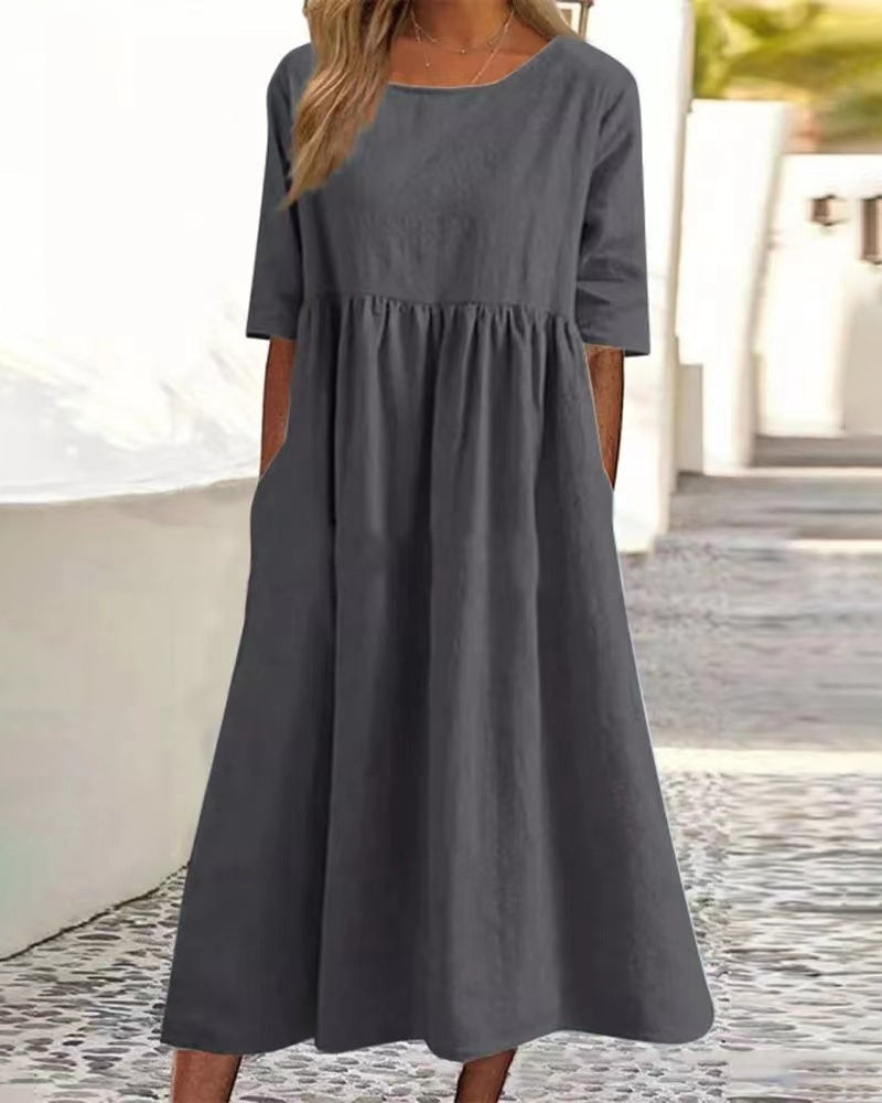Women's relaxed A-line midi dress with round neckline and functional pockets for everyday wear