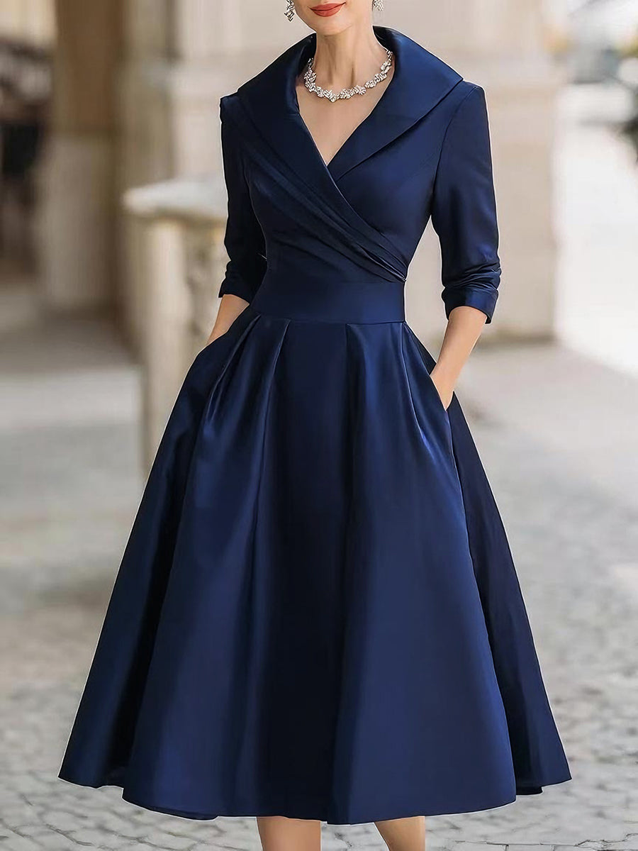 Women's black evening midi dress with wrap collar and flared skirt, elegant fitted silhouette