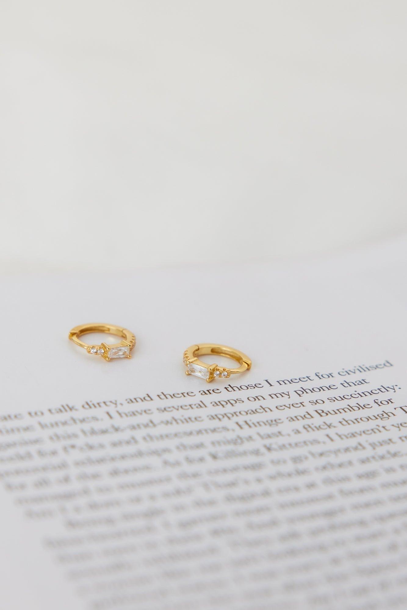 18K gold plated cubic zirconia hoop earrings set with clear CZ centerpiece for a luxe sparkle