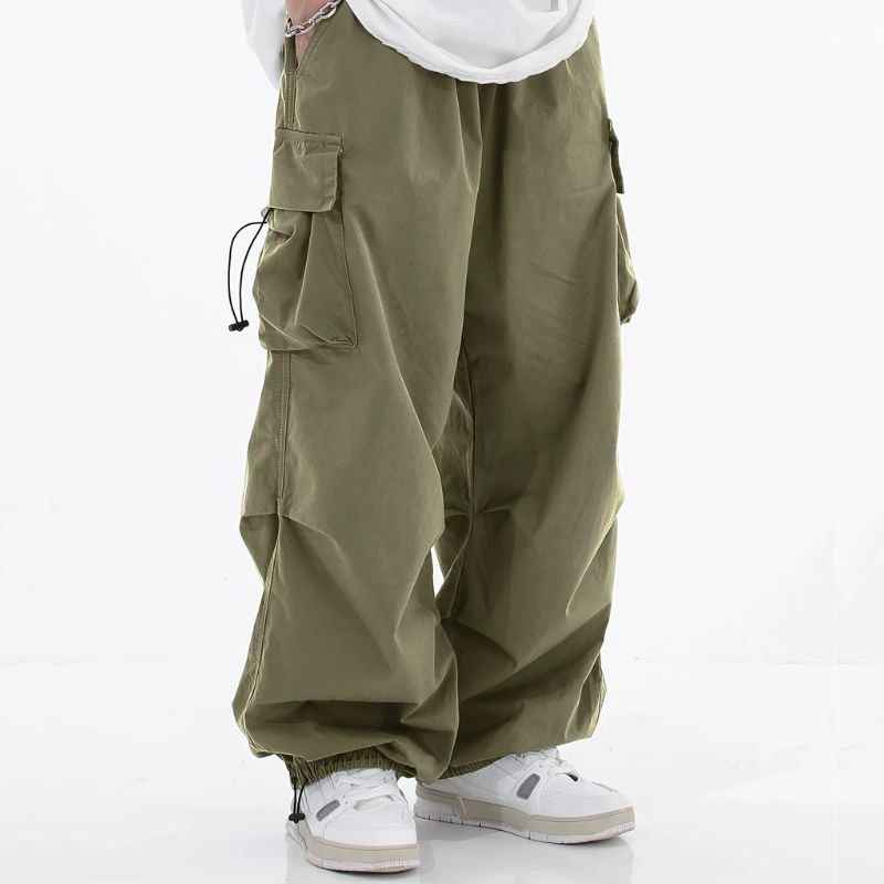Men's wide-leg cargo pants with drawstring cuffs, ample utility pockets, and relaxed streetwear silhouette