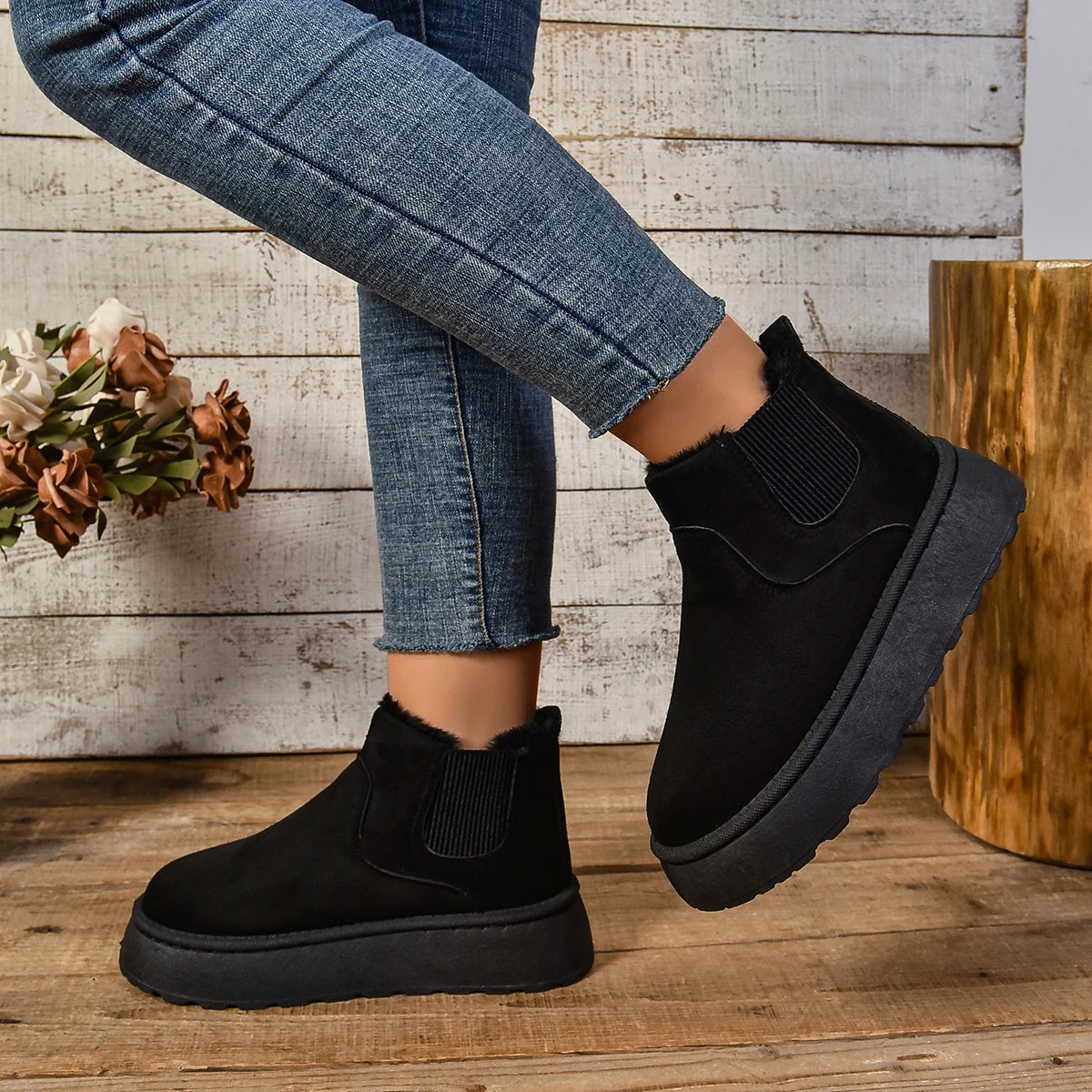 Women's black plush platform slip-on boots with warm faux fur lining and chunky sole