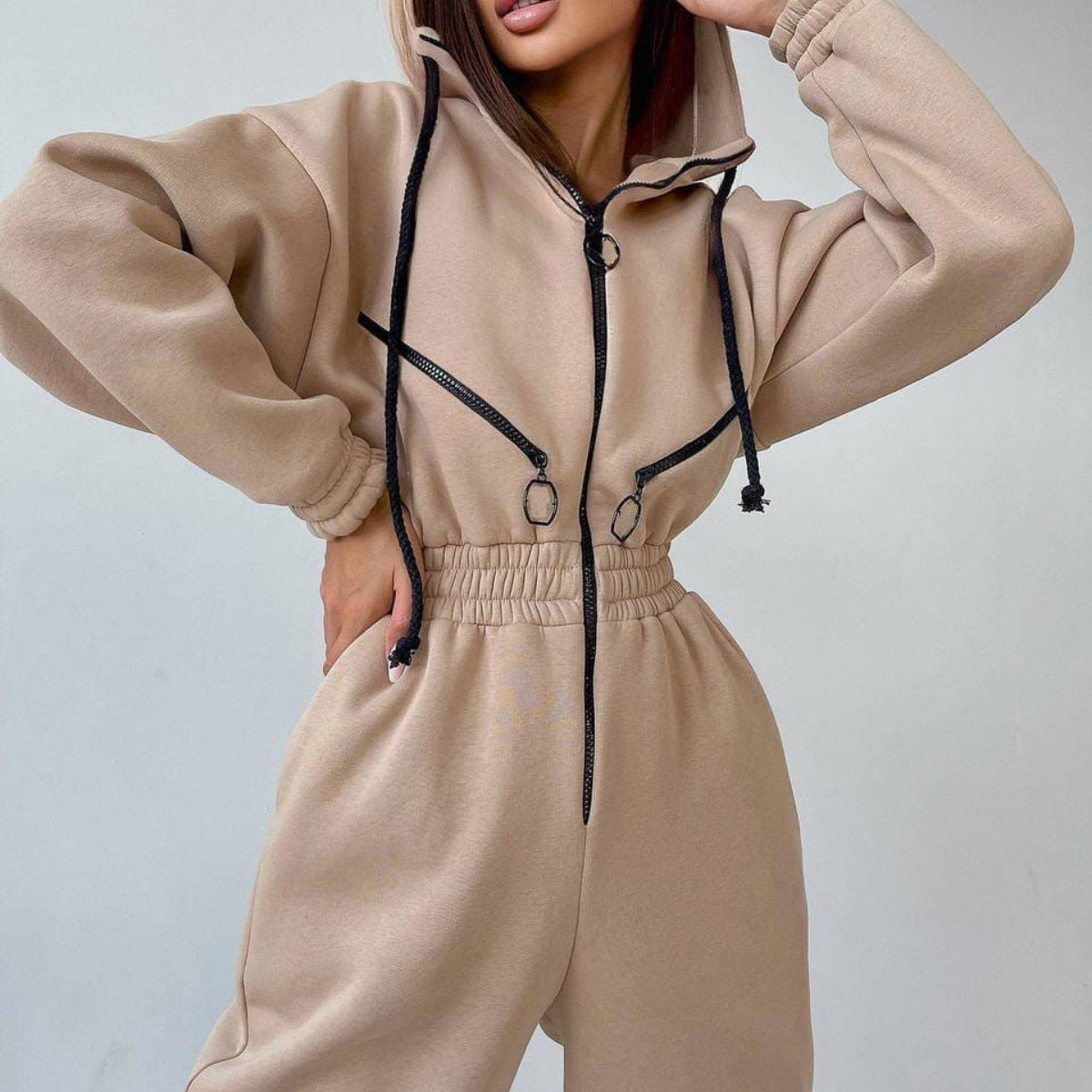 Charcoal heavyweight fleece zip-up jumpsuit with cinched waist, adjustable hood, and relaxed one-piece silhouette