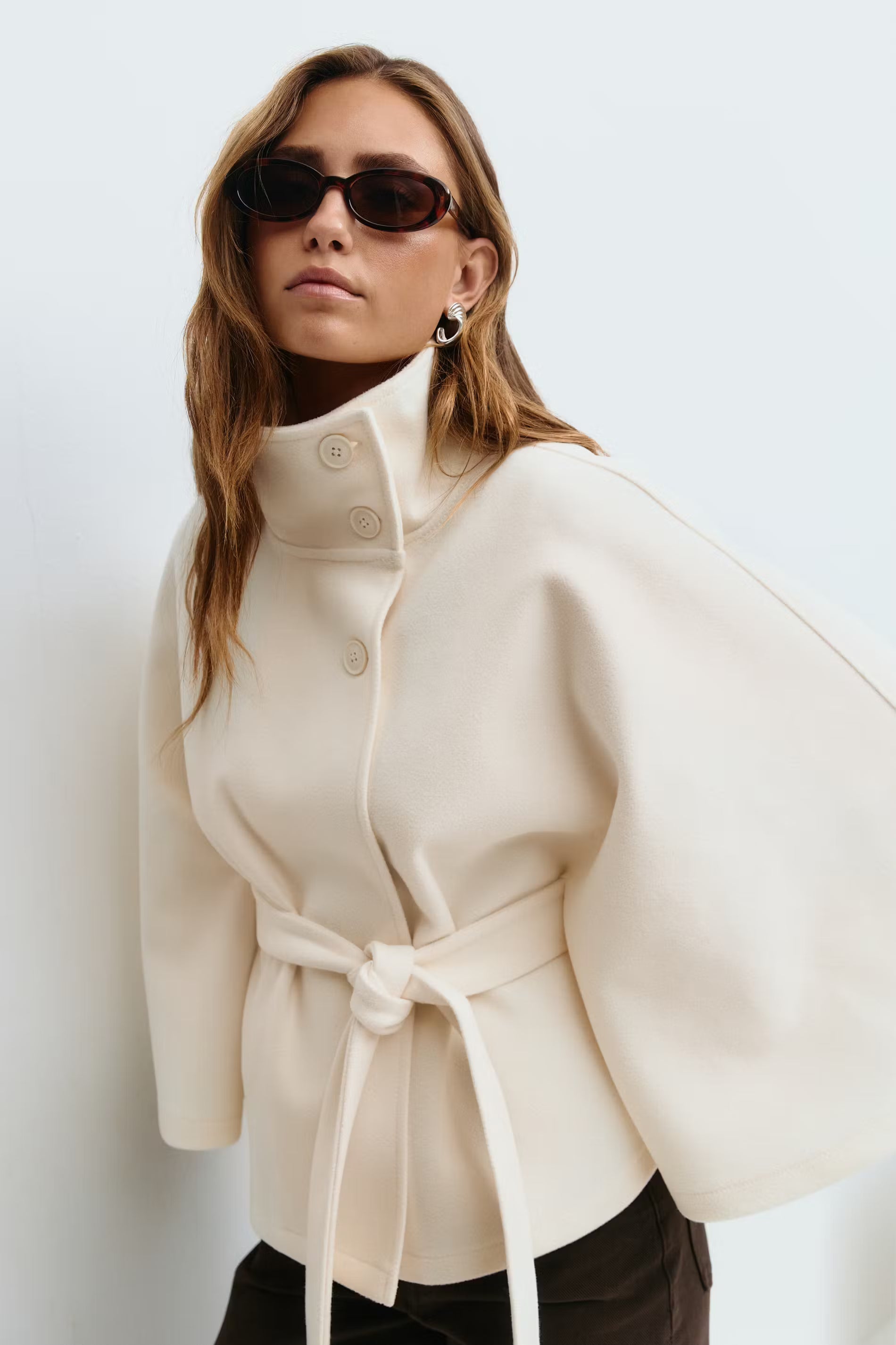 Women's belted winter cape coat with high collar, lightweight cozy warmth, modern flowing silhouette