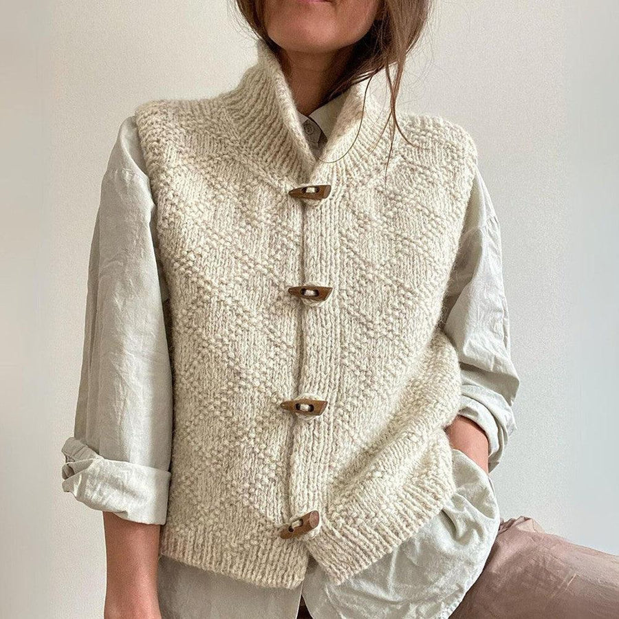 Women's cream knitted button-front winter vest with textured pattern and rustic wooden-style buttons