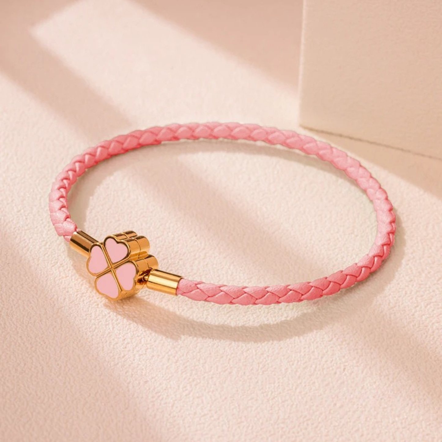 Hand-braided cowhide leather bracelet with 18K gold four-leaf clover charm, hypoallergenic tarnish-resistant