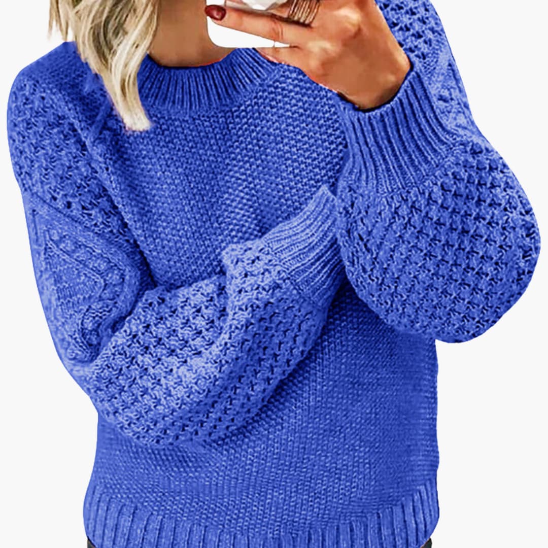 Women's knit sweater with structured sleeves, ribbed hem, and round neckline in a clean minimalist style