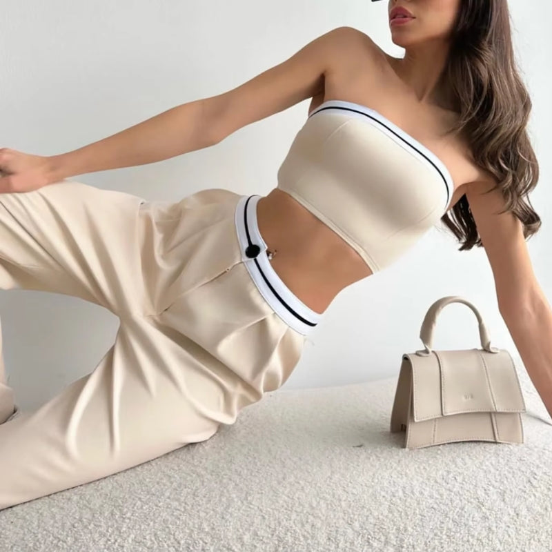 Ivory two-piece set featuring sculpted bandeau top and draped wide-leg pants with fluid silhouette