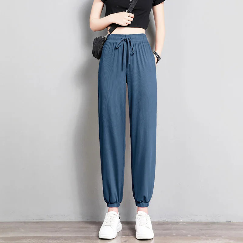 Black tapered jogger pants with adjustable drawstring waist, elastic cuffs, and side pockets