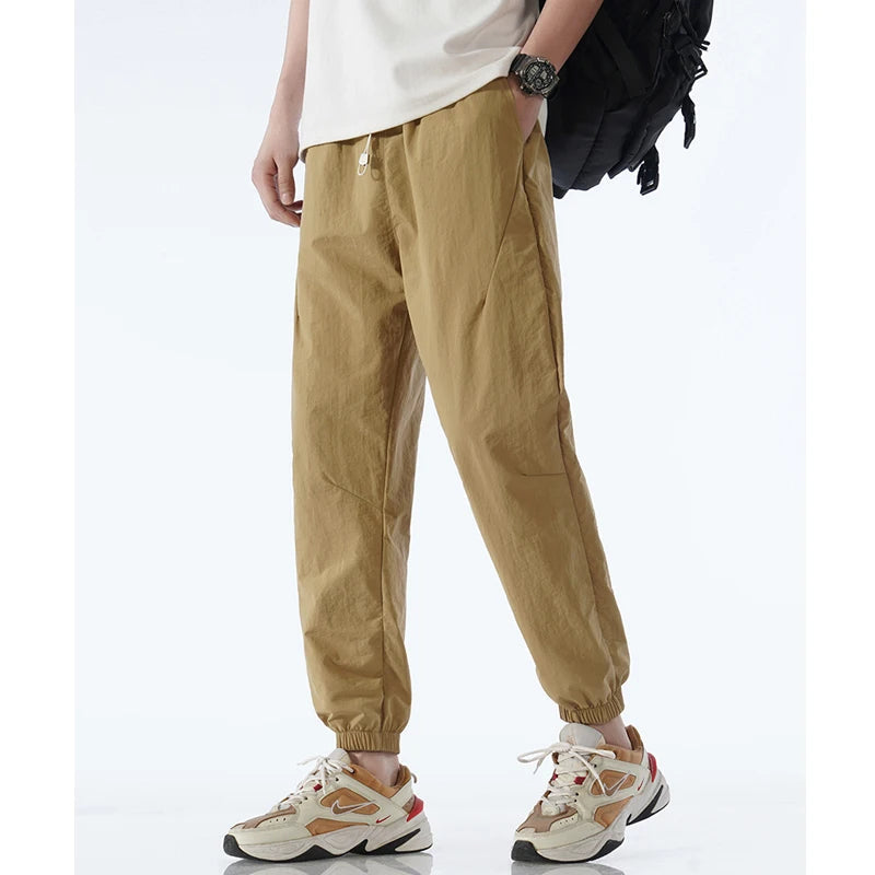 Men's gray tapered nylon jogger pants lightweight quick-dry activewear sleek modern silhouette