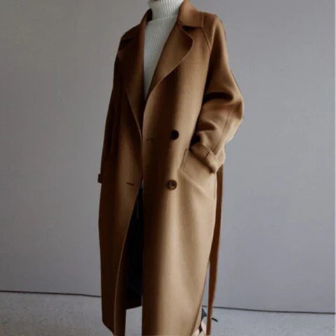 Beige long trench coat relaxed silhouette with double button front closure and clean minimal drape