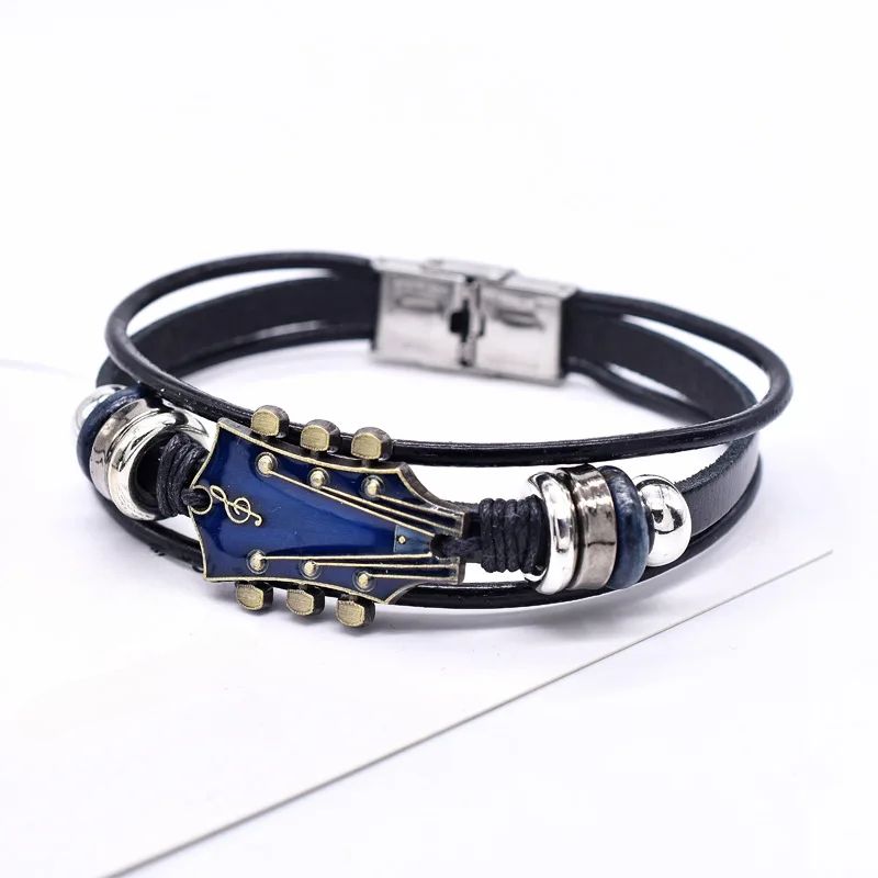Brown leather guitar bracelet vintage-inspired music accessory with engraved guitar charm detail