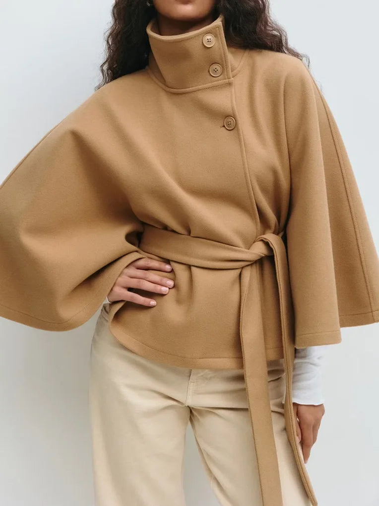 Black high collar coat flared cape sleeves asymmetrical placket detachable belt modern women