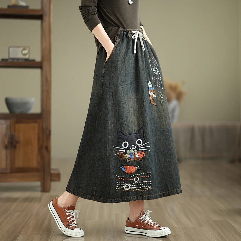 Women's hand embroidered denim maxi skirt A-line silhouette washed finish contrast stitching artisanal detail