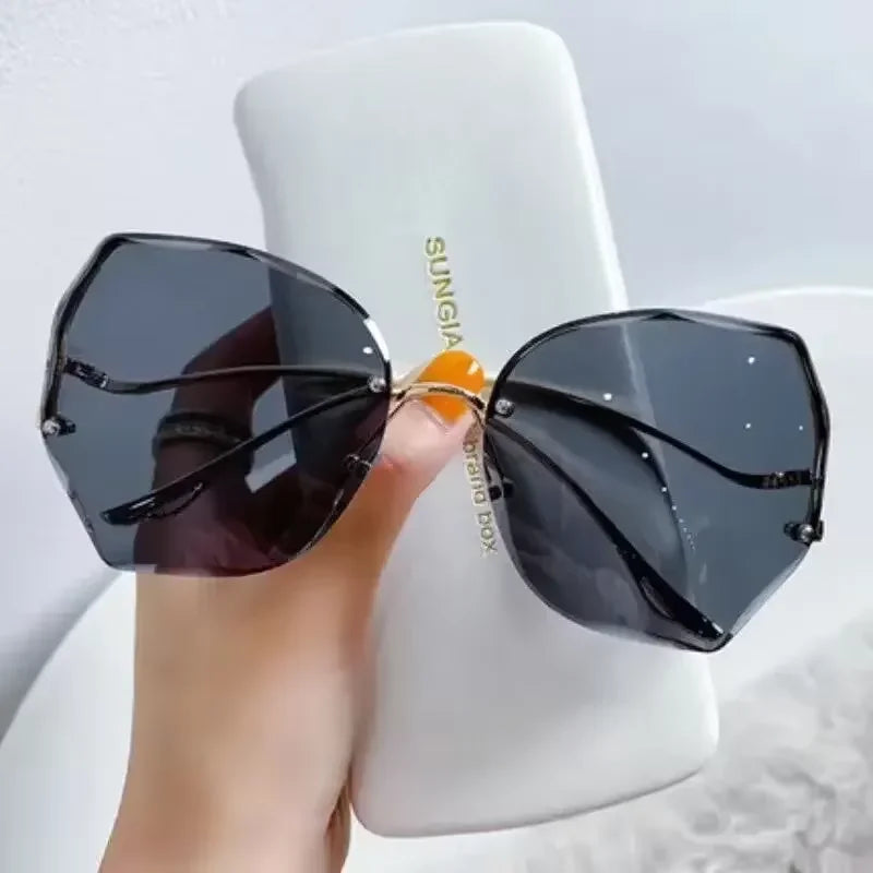 Women's rimless butterfly sunglasses bold petal-cut gradient UV400 lenses gold-tone temples