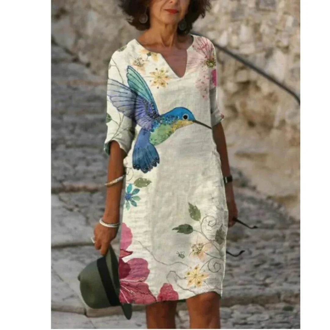 Women's floral midi dress, V-neck, artistic face print with delicate floral accents, sophisticated everyday style