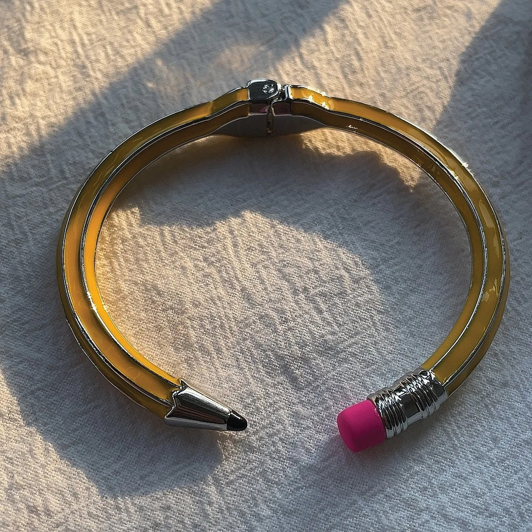 Pink eraser-inspired polished metal cuff bracelet, waterproof statement accessory for creative professionals