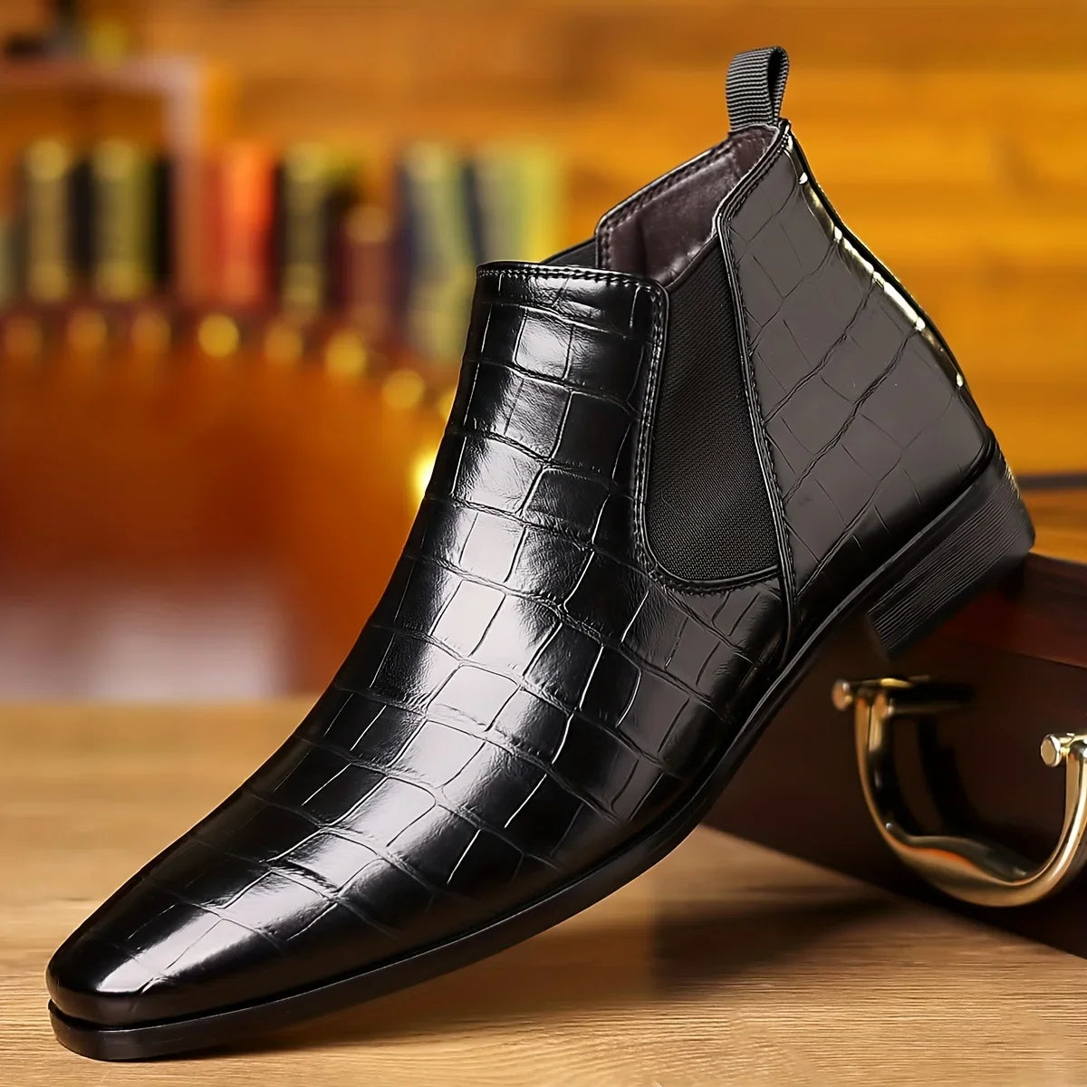 Black crocodile-embossed vegan leather Chelsea boots with high-gloss finish and cushioned insole