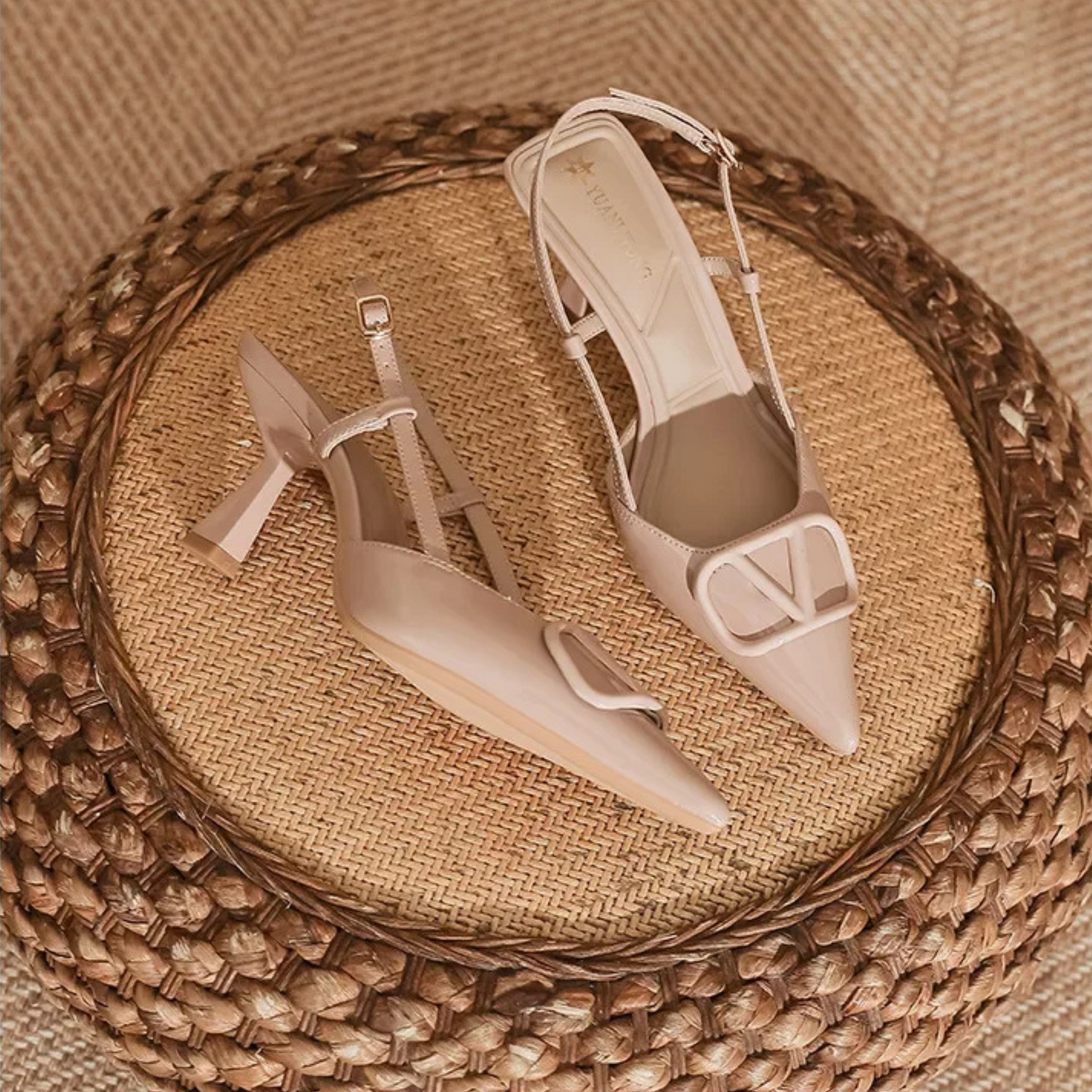 Nude slingback stiletto heels with pointed toe, adjustable ankle strap, and bold oversized buckle