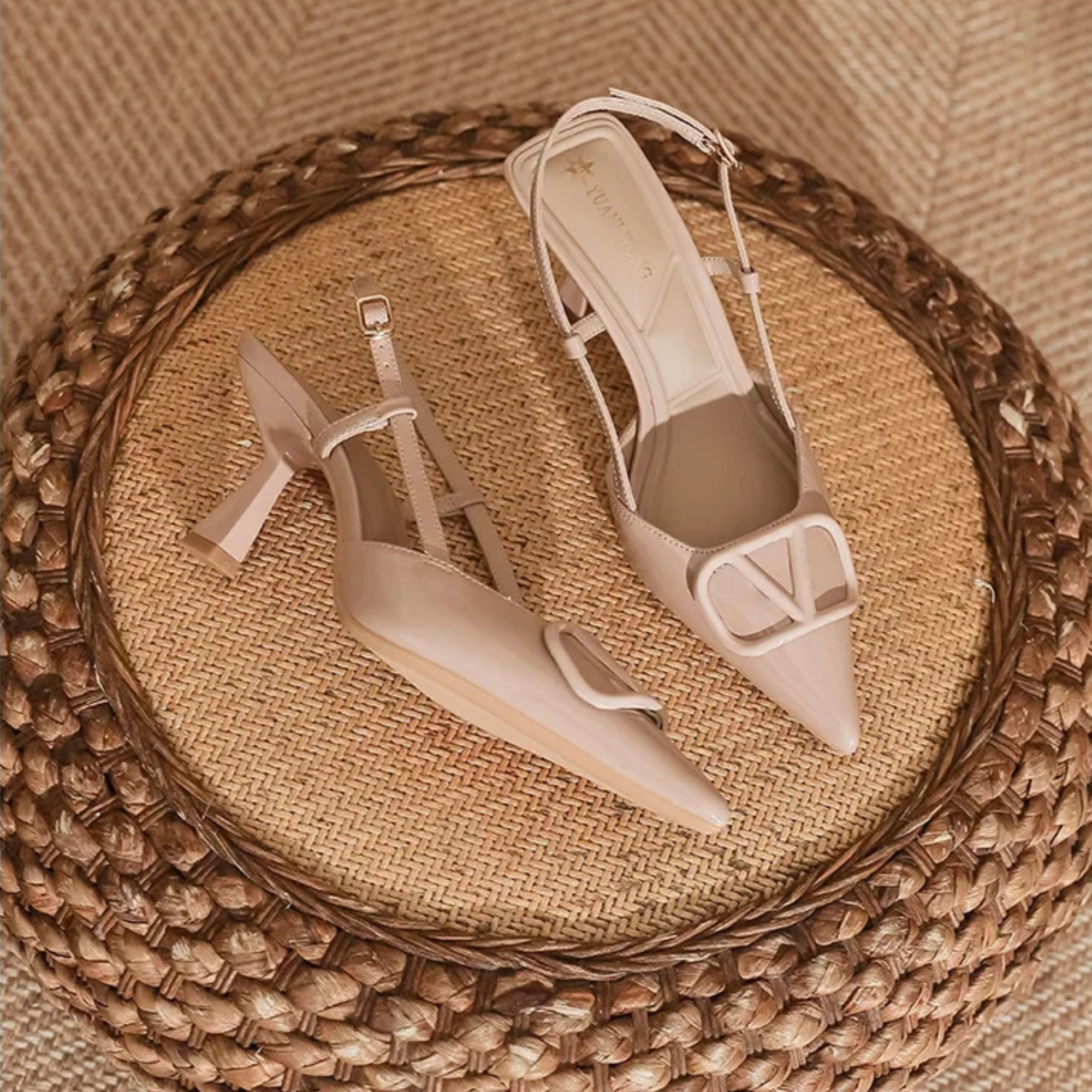 Nude slingback stiletto heels with pointed toe, adjustable ankle strap, and bold oversized buckle