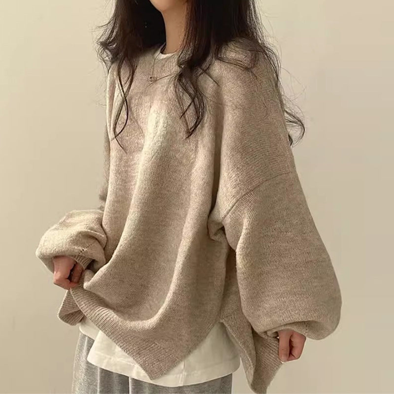 Women's oversized knit sweater neutral tone split hem side slit relaxed casual contemporary silhouette