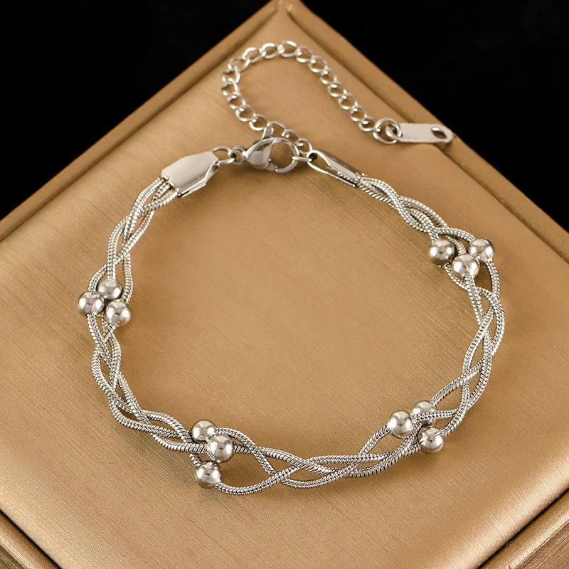 Gold or silver triple-layer snake chain bracelet with bead accents, stainless steel layered design
