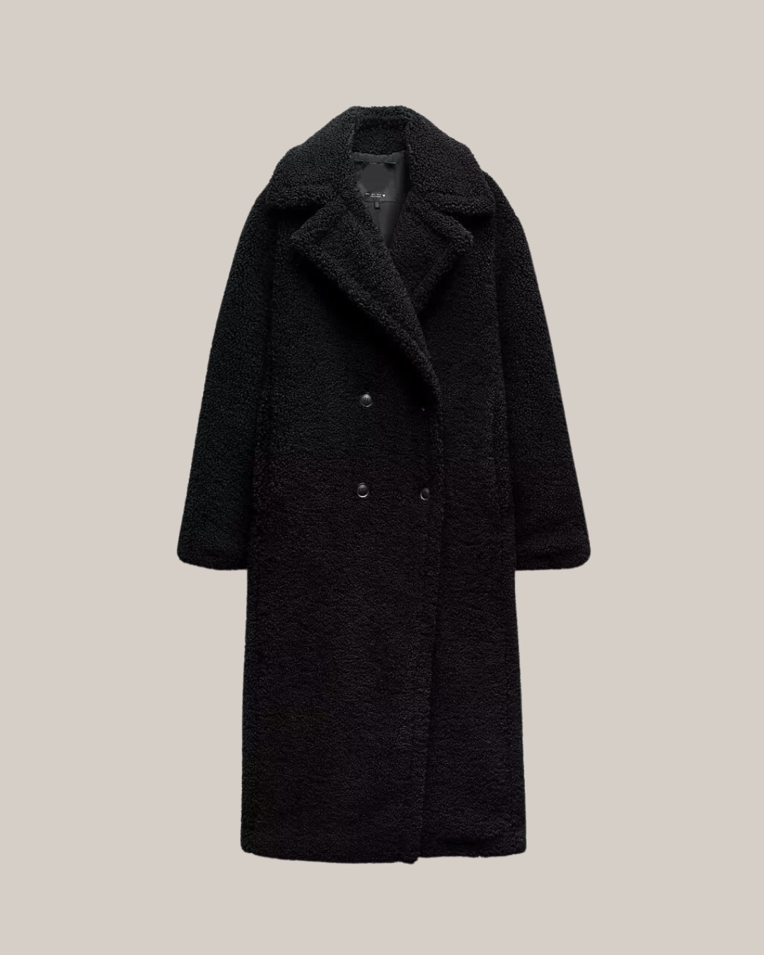 Women's long double-breasted teddy coat in neutral tone with lapel collar, relaxed fit winter outerwear