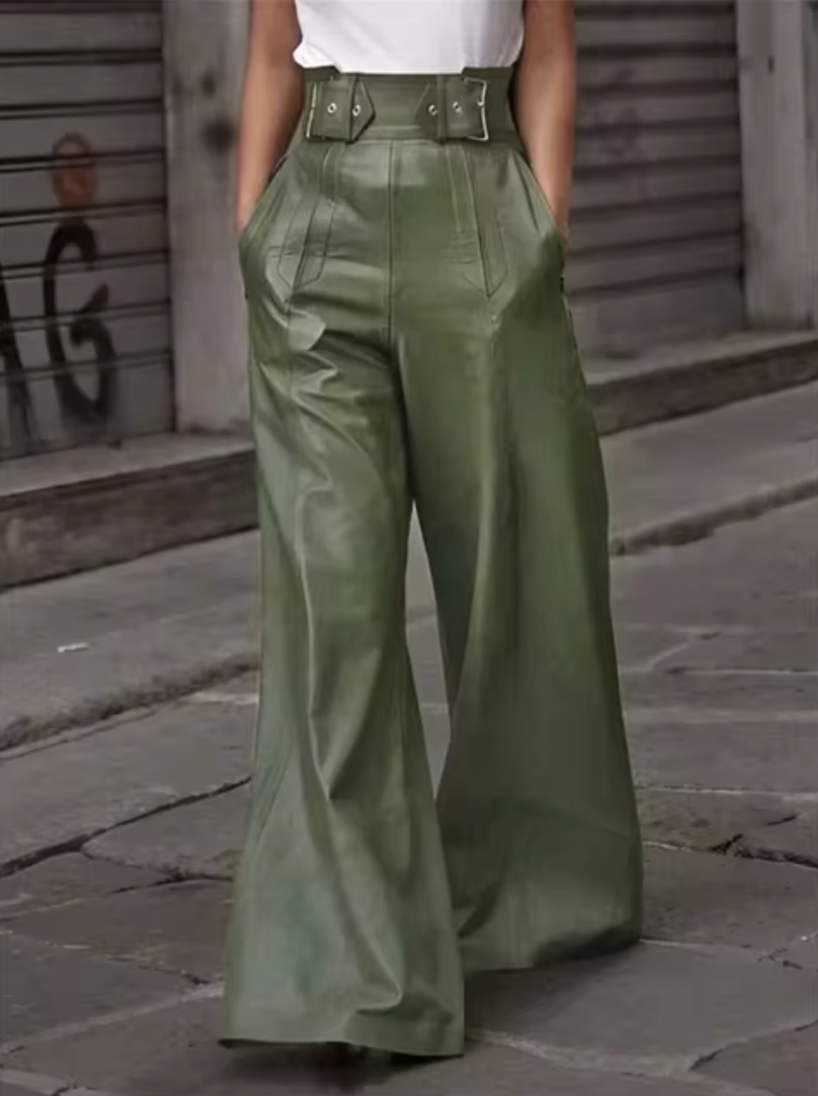 Women's black high-waist wide-leg leather pants with elegant glossy finish and flowing silhouette