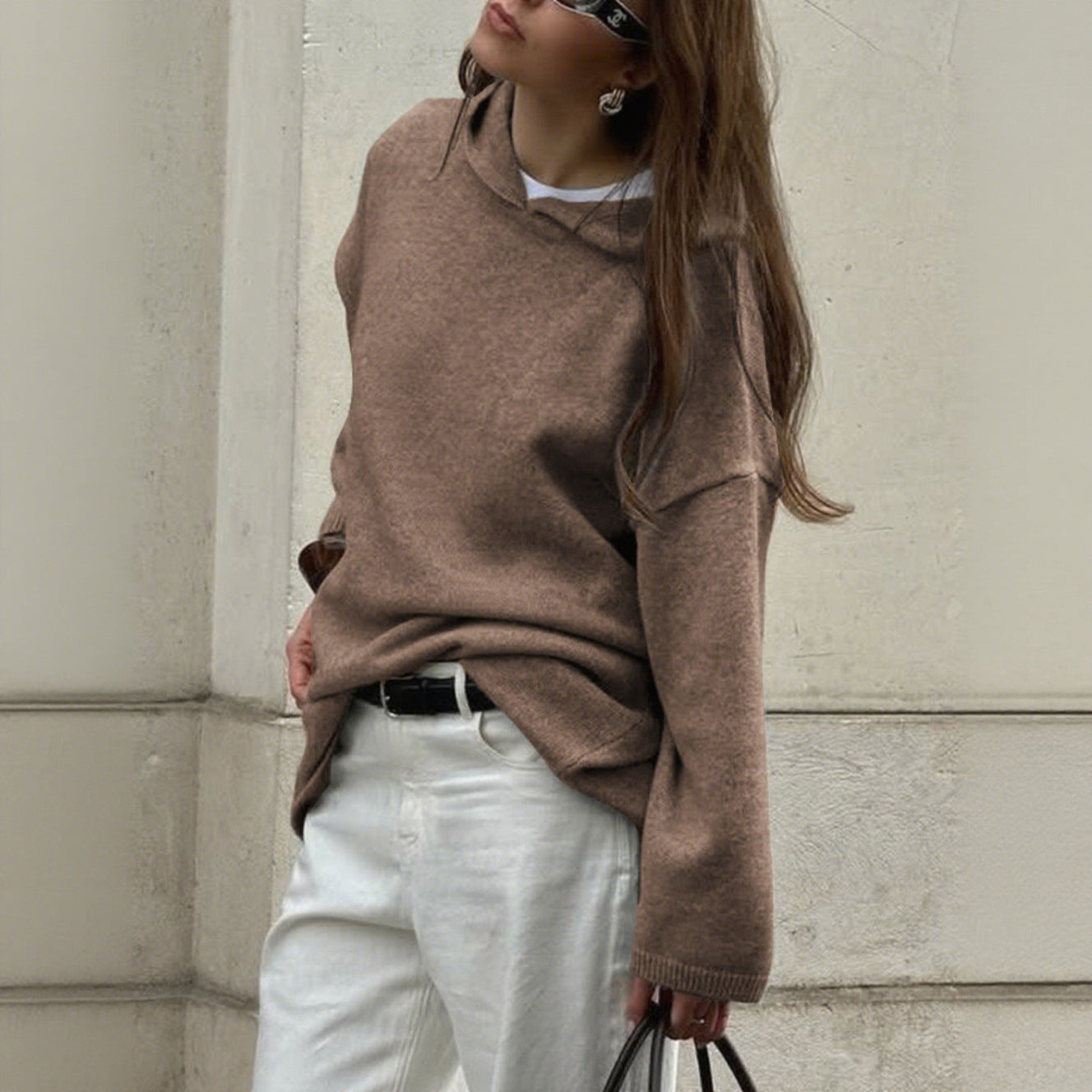 Women's oversized crew neck knit sweater in soft neutral tones with relaxed drapey silhouette