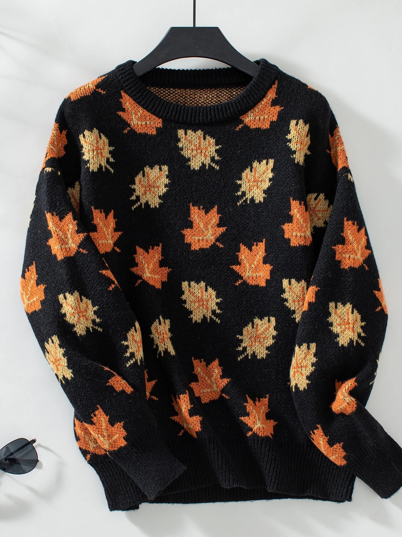 Women's maple leaf knit sweater in autumn hues, relaxed fit with ribbed cuffs for cozy fall layering