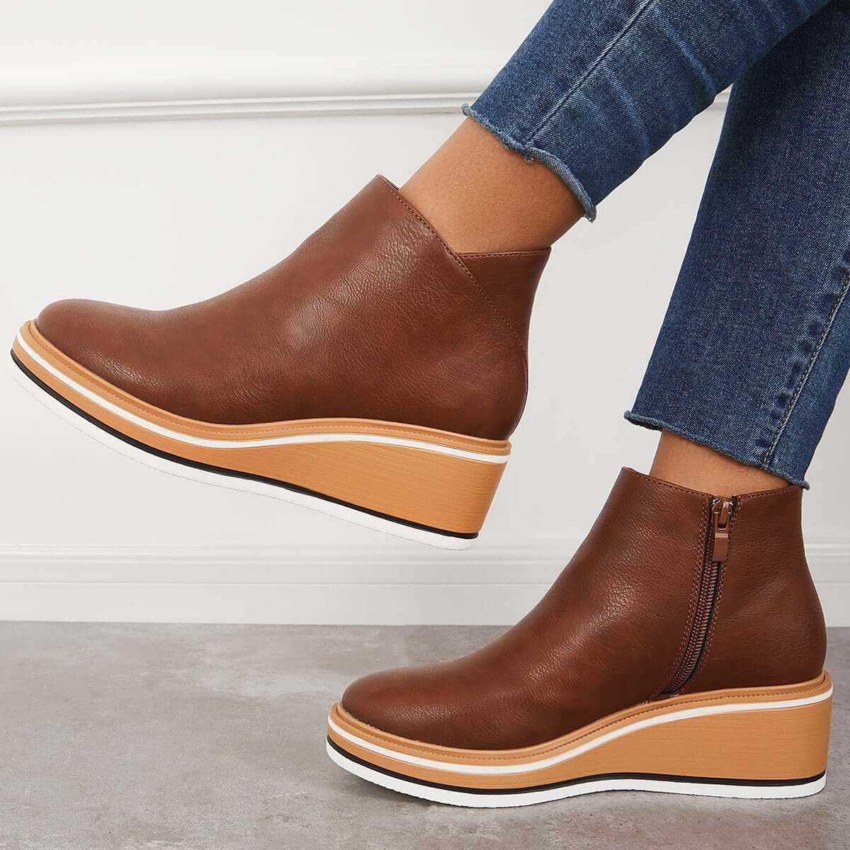 Women's black platform ankle boots with side zipper, elegant contemporary style for height and stability