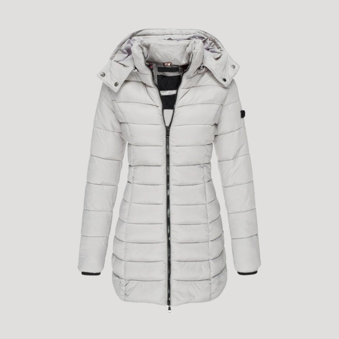 Women's long hooded puffer winter coat in neutral tone, insulated cozy chic outerwear with full-length silhouette
