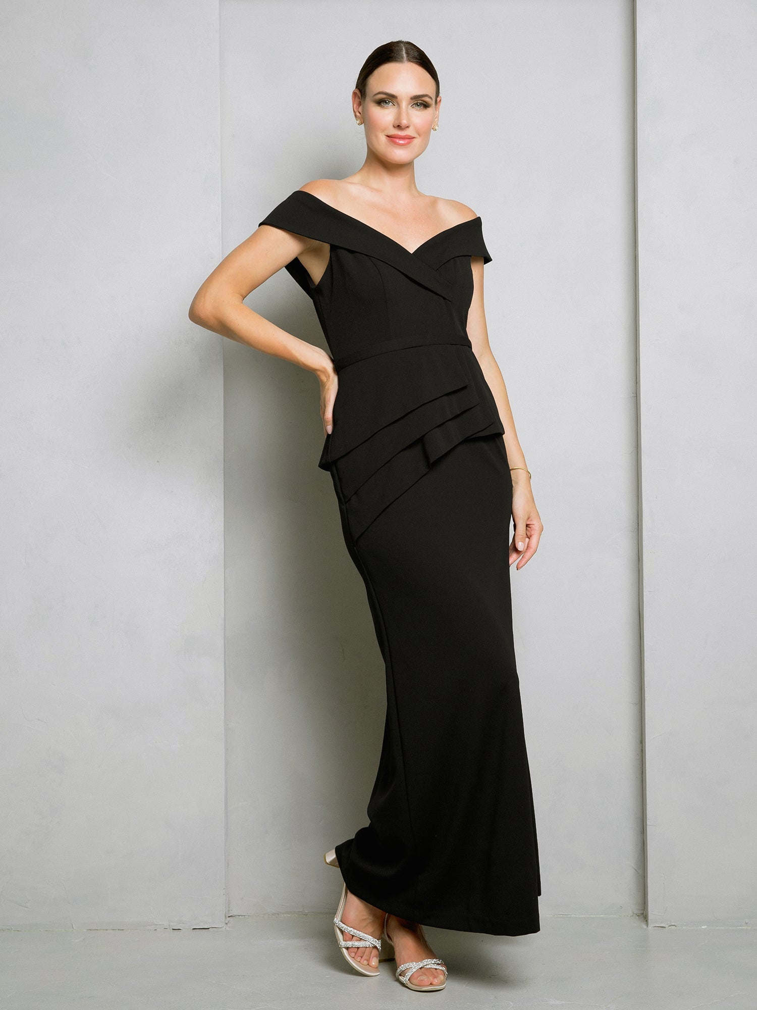 Black off-shoulder floor-length formal gown with structured bodice and elegant waist peplum