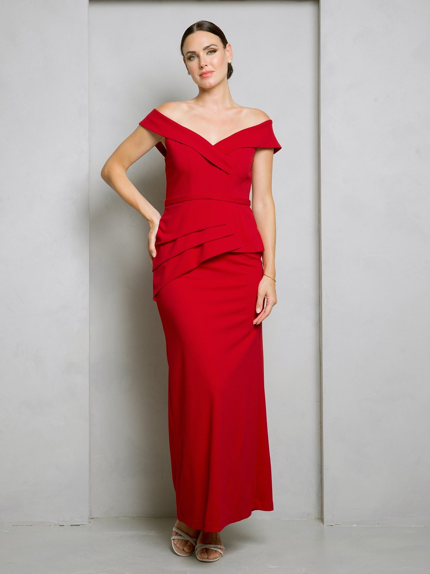 Black off-shoulder floor-length formal gown with structured bodice and waist peplum