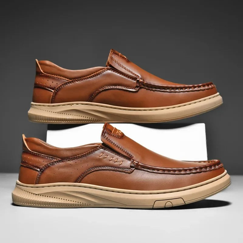 Black slip-on men's loafers with cushioned interior, perforated side accents, and classic structured upper