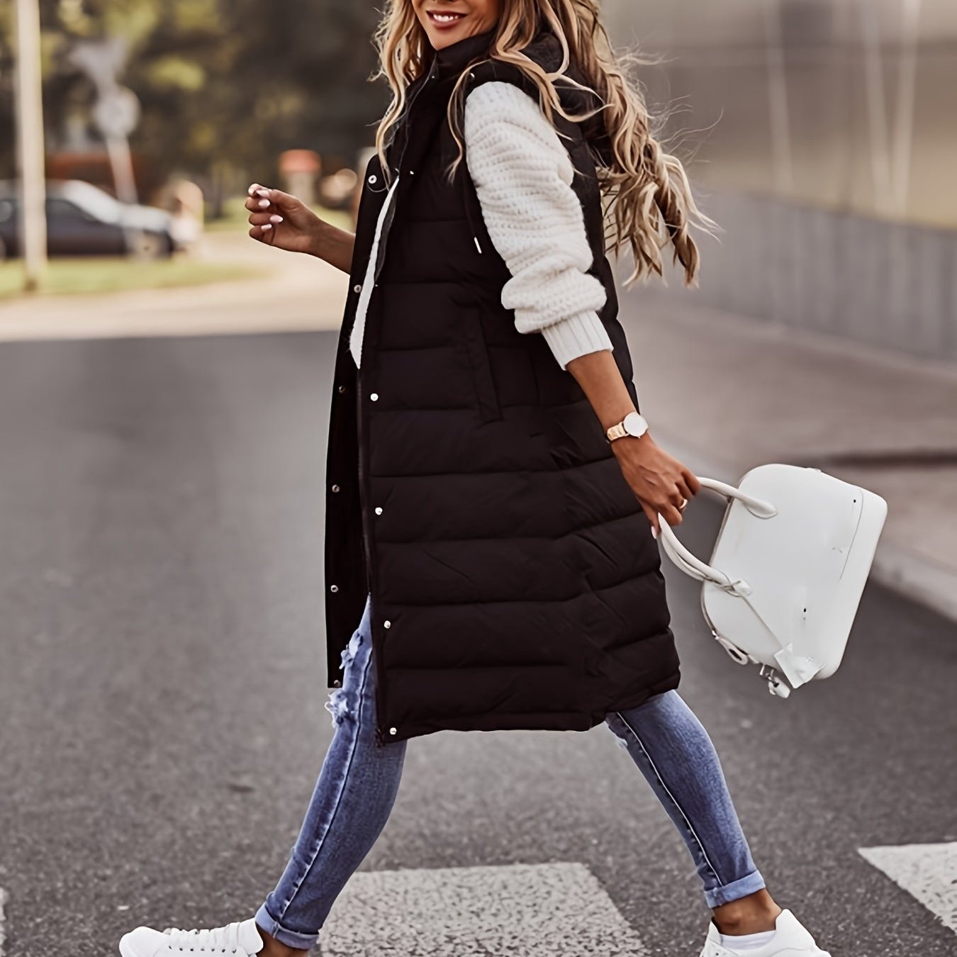 Women's long quilted zip-up puffer vest in neutral tone, sleek longline silhouette for everyday layering